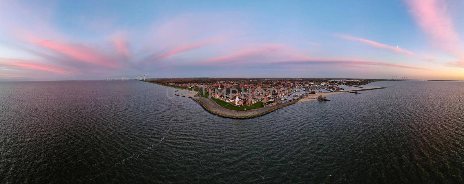 Urk Flevoland Netherlands, harbor with the lighthouse on a bright summer in the Netherlands at the historical village of Urk alongside the lake Ijsselmeer Europe