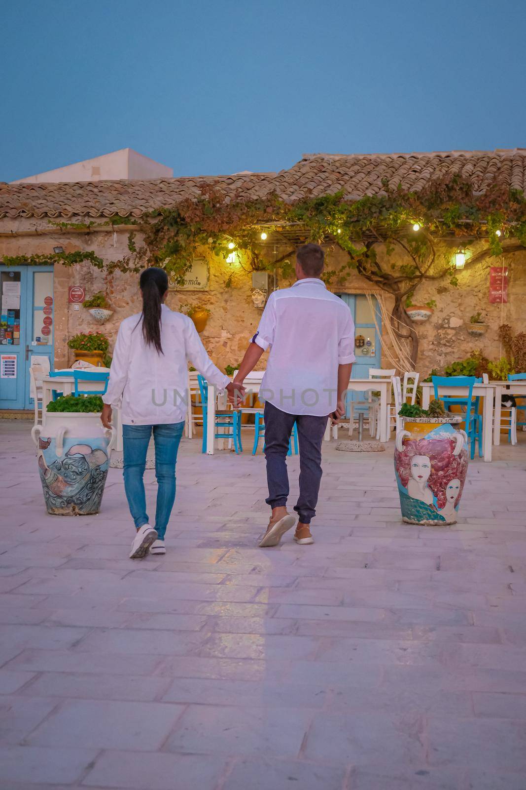 The picturesque village of Marzamemi, in the province of Syracuse, Sicily Italy, a couple on vacation in Sicilia