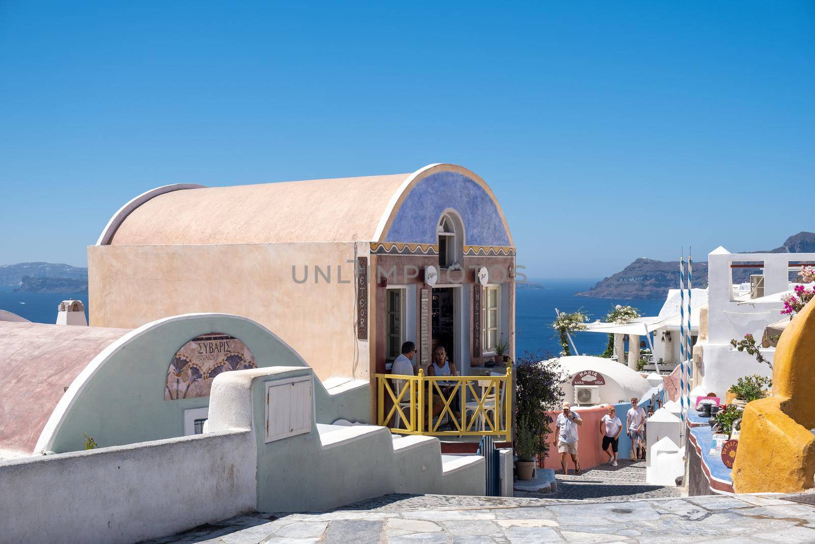 Santorini Greece August 2020, streets of Oia on a early morning with cafe and restaurant by fokkebok