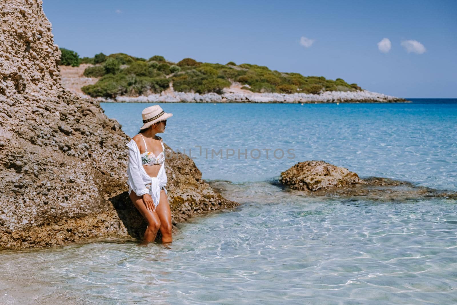 Tropical beach of Voulisma beach, Istron, Crete, Greece, couple on vacation in Greece by fokkebok