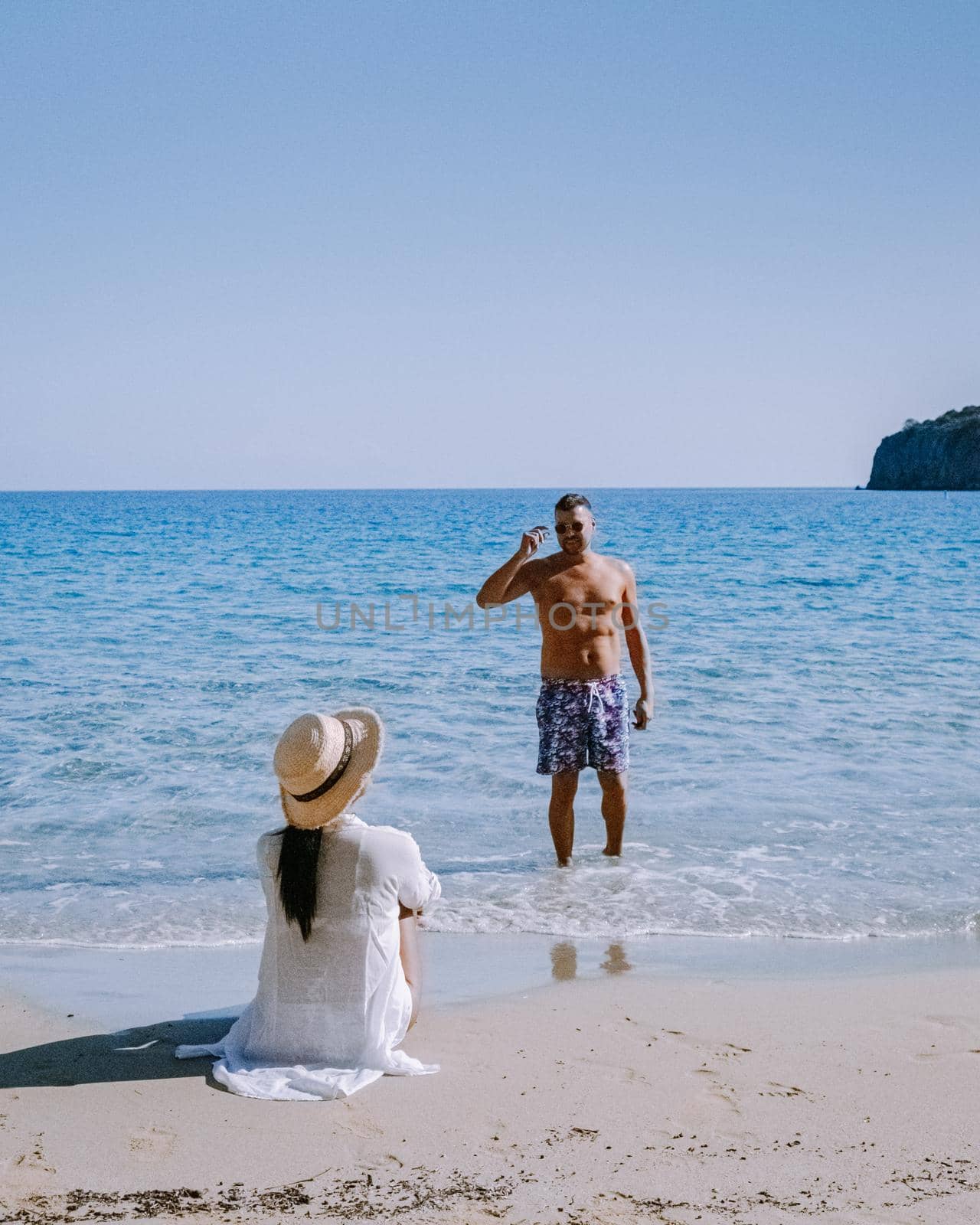 Tropical beach of Voulisma beach, Istron, Crete, Greece, couple on vacation in Greece by fokkebok