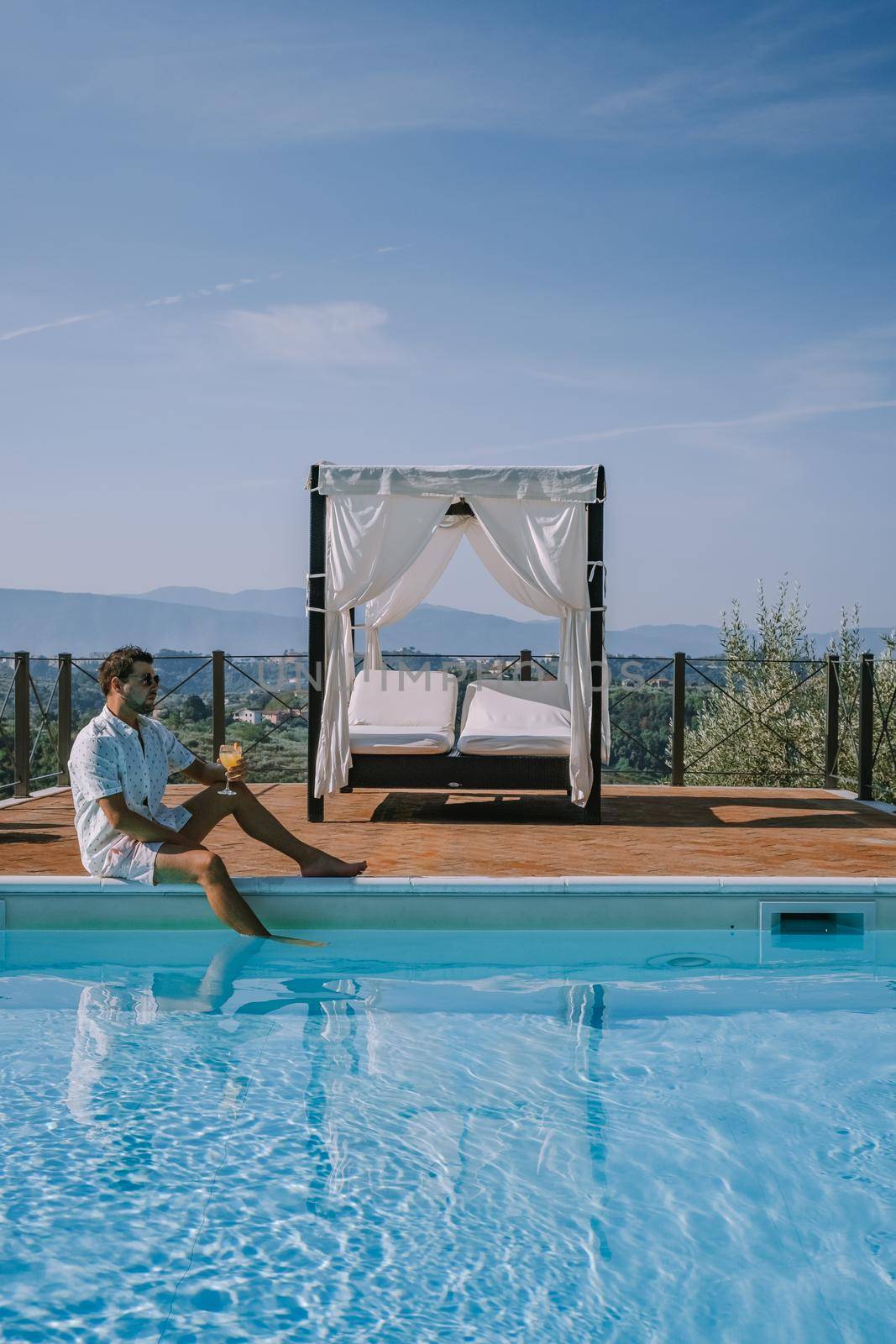 Luxury country house with swimming pool in Italy, Couple on Vacation at luxury villa in Italy, men and woman watching sunset by fokkebok