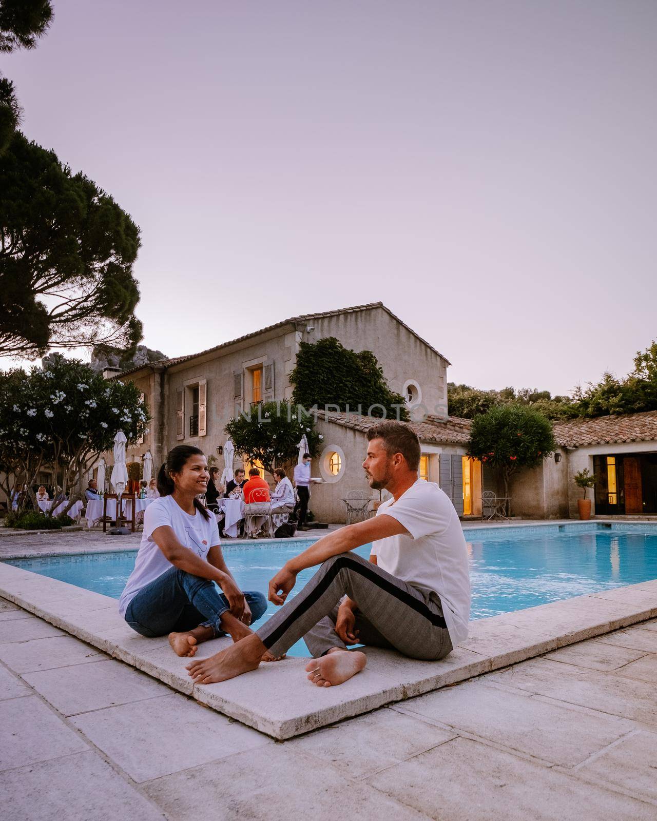 couple relaxing by the pool in the Provence France, men and woman relaxing by pool at luxury resort by fokkebok