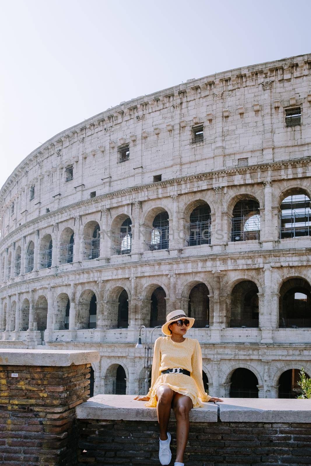 View of Colosseum in Rome and morning sun, Italy, Europe. Young woman on city trip Rome