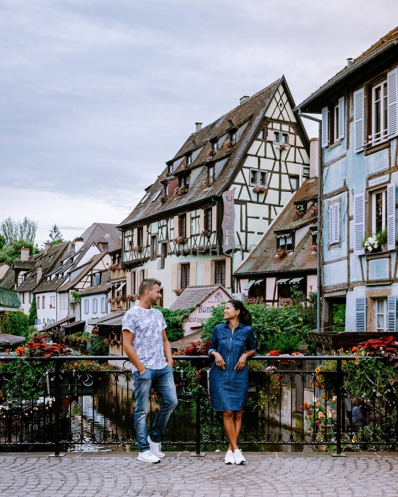 couple on city trip Colmar, Alsace, France. Petite Venice, water canal and traditional half timbered houses. Colmar is a charming town in Alsace, France. Beautiful view of colorful romantic city Colmar, France, Alsace by fokkebok