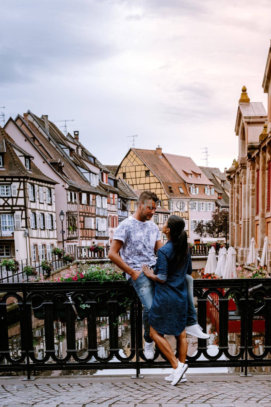 couple on city trip Colmar, Alsace, France. Petite Venice, water canal and traditional half timbered houses. Colmar is a charming town in Alsace, France. Beautiful view of colorful romantic city Colmar, France, Alsace by fokkebok