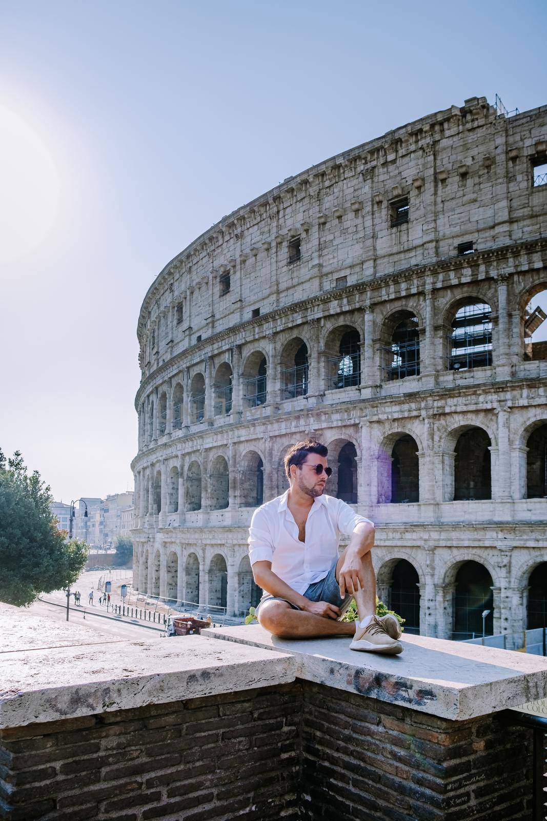 View of Colosseum in Rome and morning sun, Italy, Europe. young guy on city trip Rome