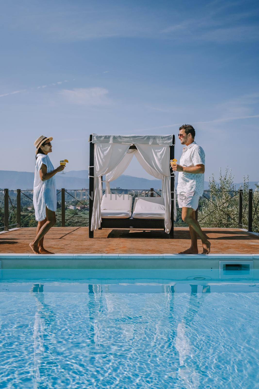 Luxury country house with swimming pool in Italy, Couple on Vacation at luxury villa in Italy, men and woman watching sunset by fokkebok