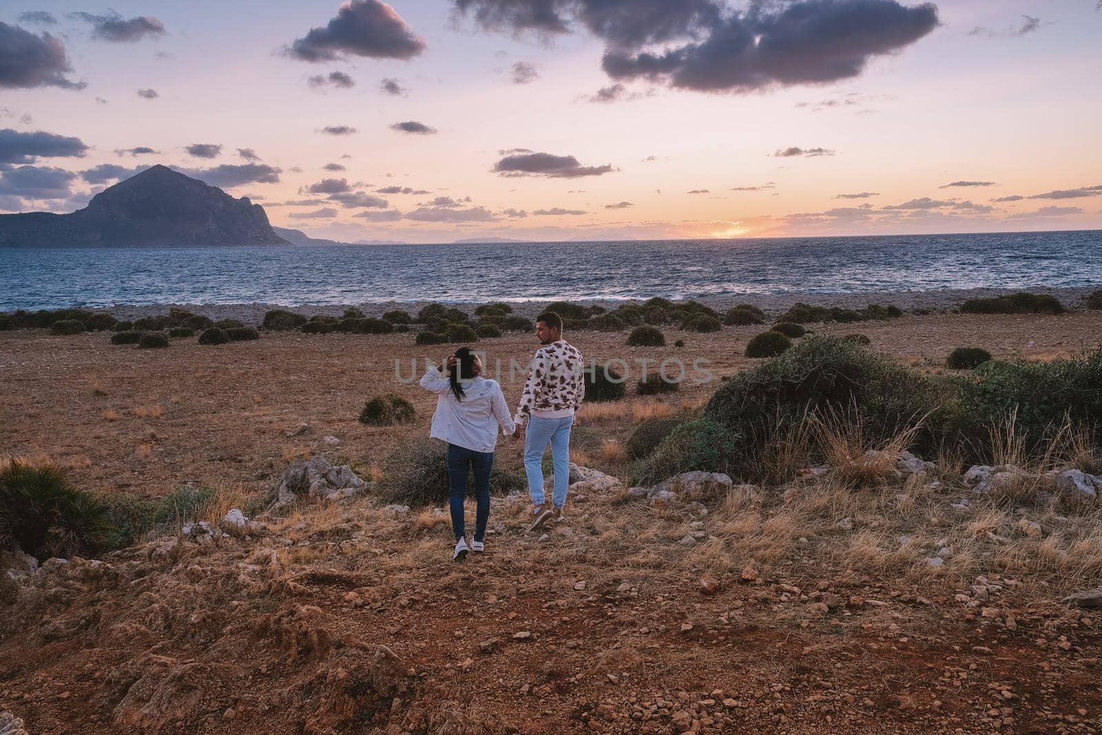 San Vito Lo Capo Sicilia, couple men and woman mid age visiting the beach of San Vito Lo Capo Sicily by fokkebok