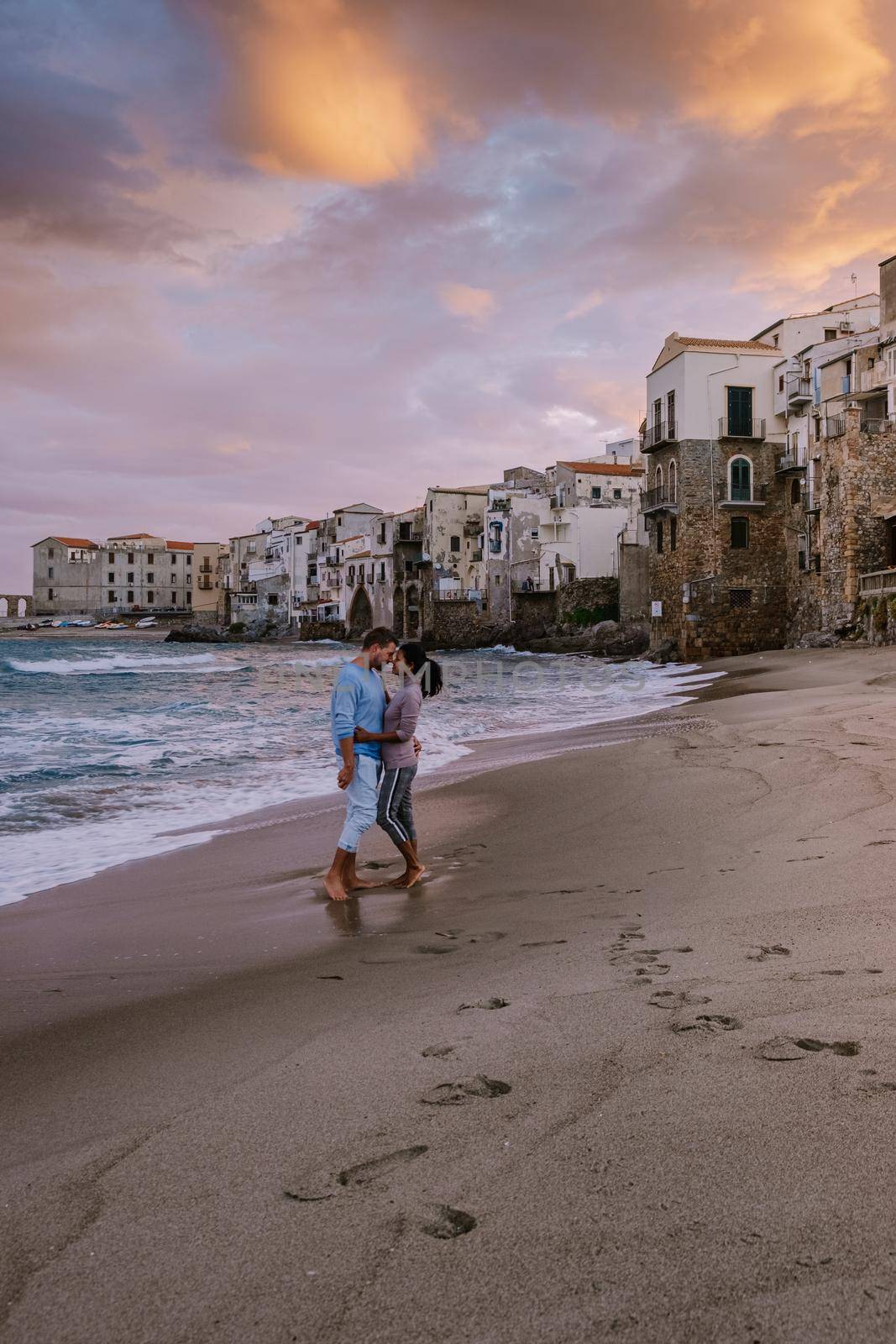 Cefalu, the medieval village of Sicily island, Province of Palermo, Italy. Europe, a couple on vacation at the Italian Island Sicilia