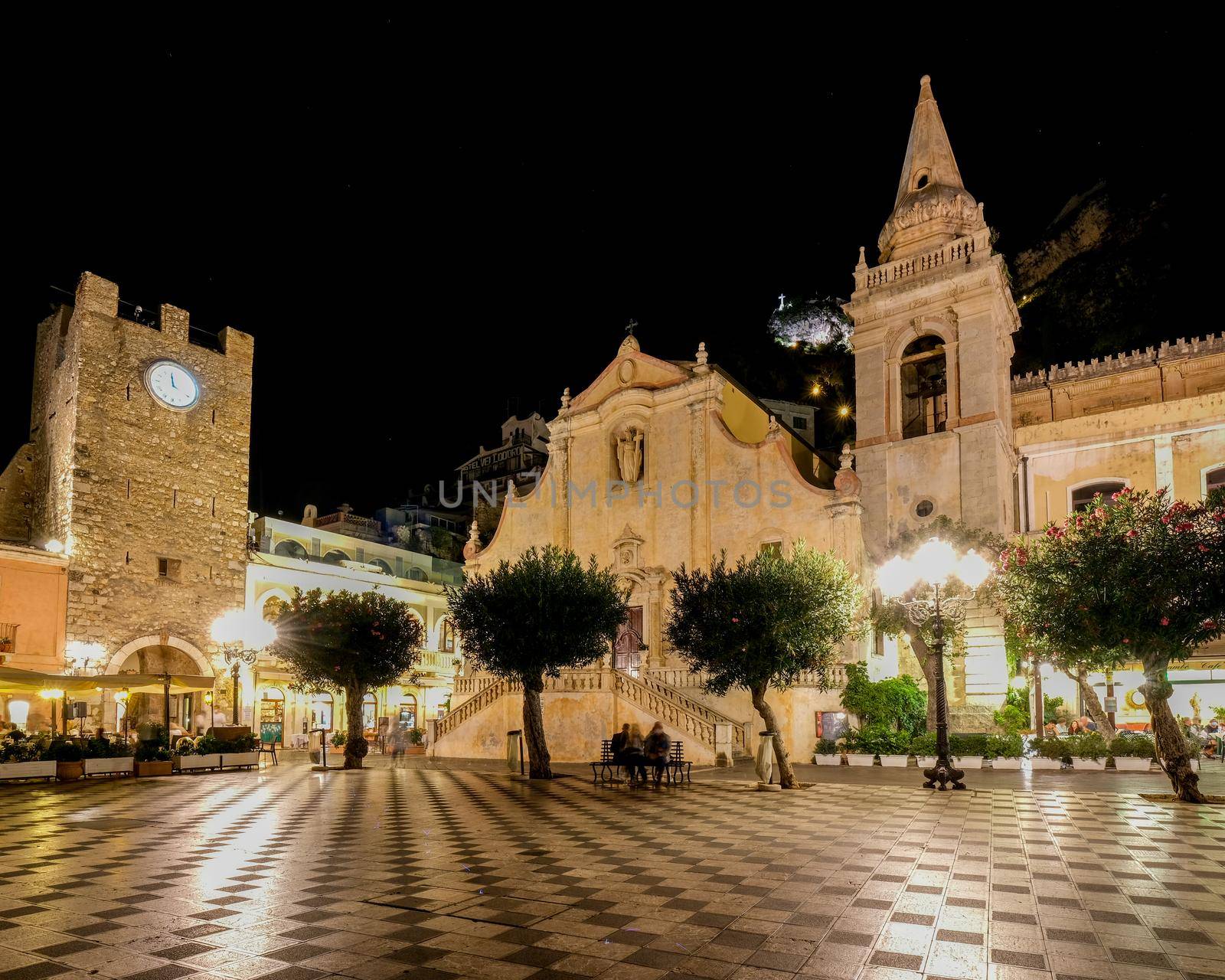 Taormina Sicily during sunset in the old town with narrow streets and lights by fokkebok