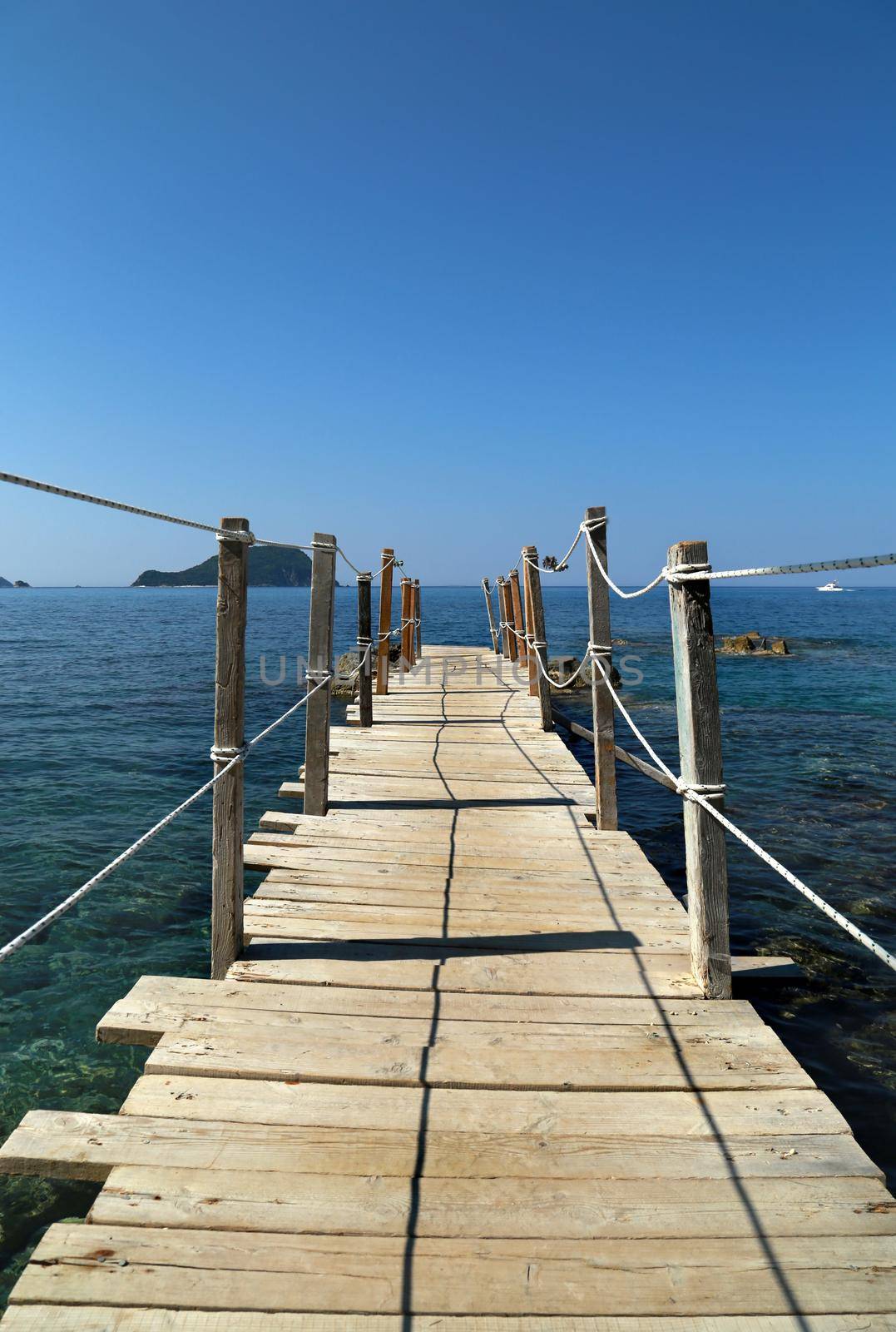 Close up wooden bridge leading to horizon, sea ocean. Pathway to future, adventure world, goal reaching, beginning, discover concept.