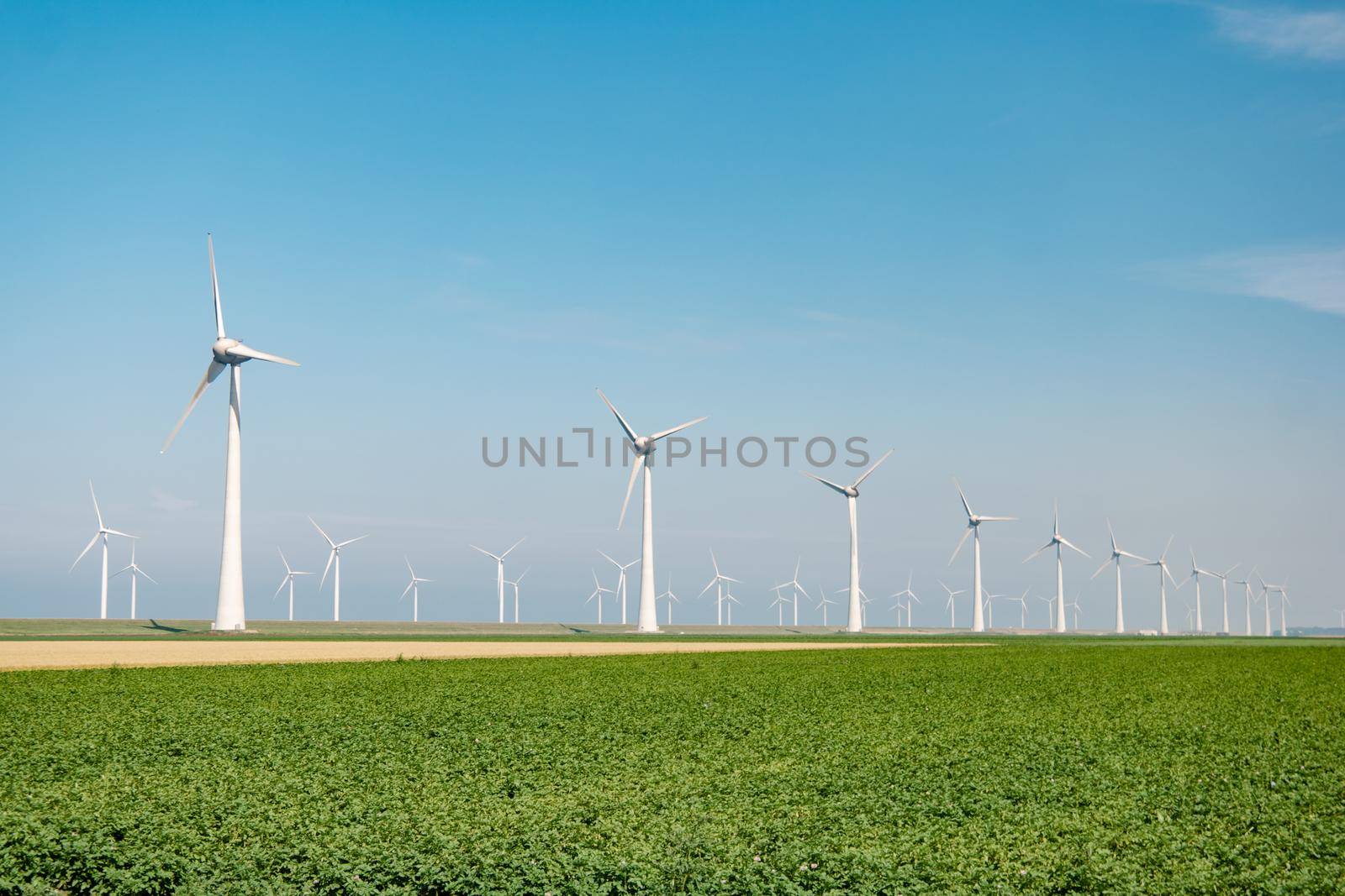 offshore windmill park with stormy clouds and a blue sky, windmill park in the ocean. Netherlands Europe