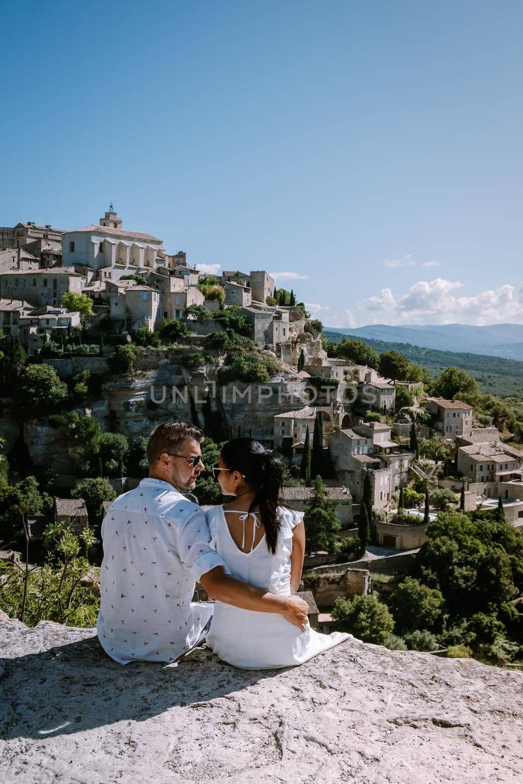 couple visit the old town of Gordes Provence,Blooming purple lavender fields at Senanque monastery, Provence, southern France by fokkebok