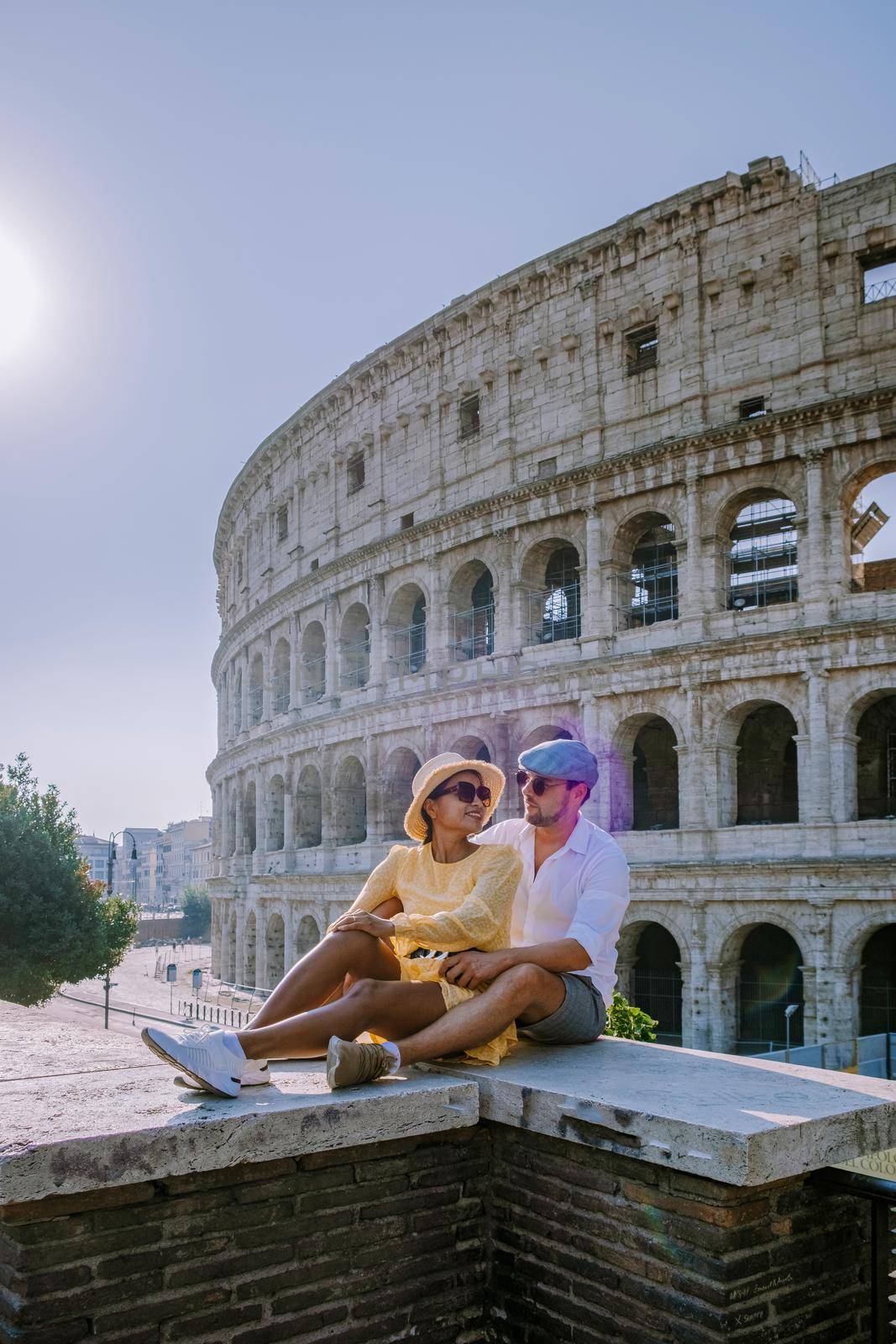 View of Colosseum in Rome and morning sun, Italy, Europe. Couple on city trip in Rome