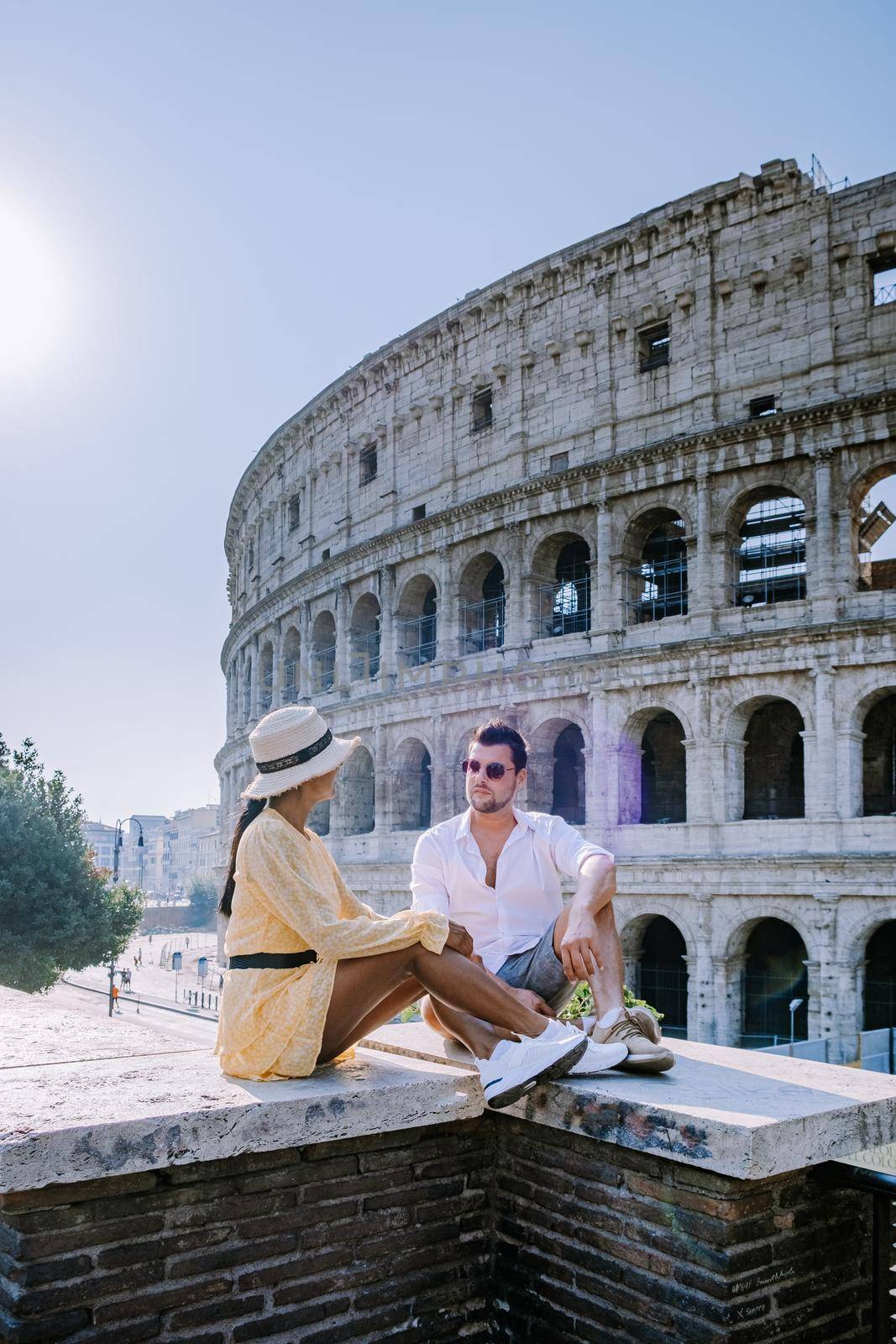 View of Colosseum in Rome and morning sun, Italy, Europe. Couple on city trip in Rome