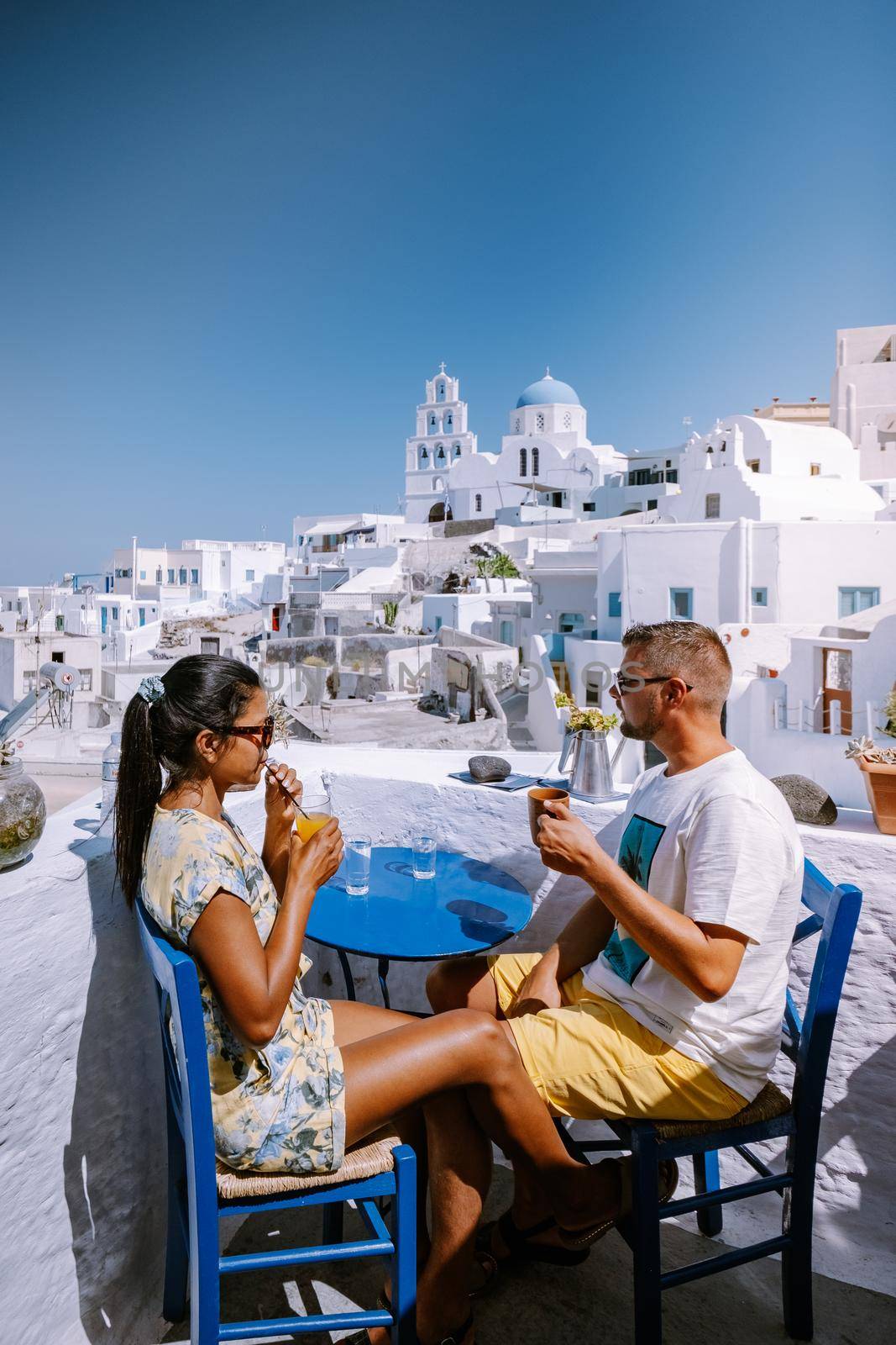 Pyrgos, Santorini, Greece. Famous attraction of white village with cobbled streets, Greek Cyclades Islands, Aegean Sea couple on vacation Santorini Greece Europe