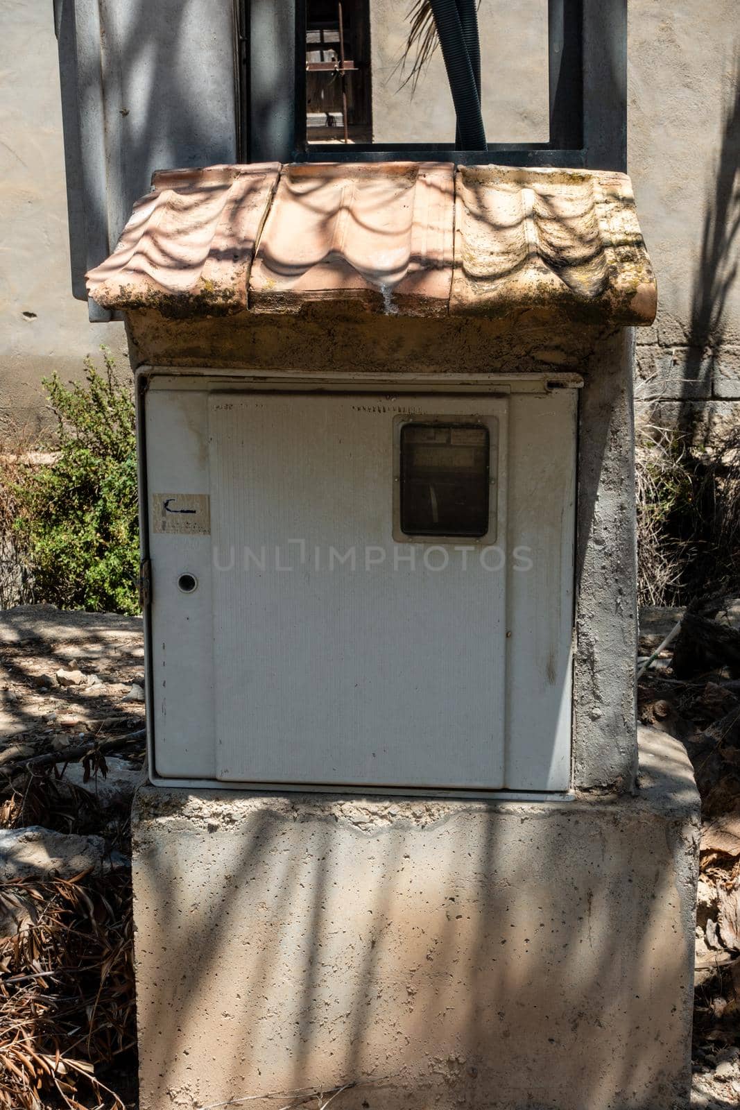 electric meter box with a tiled roof