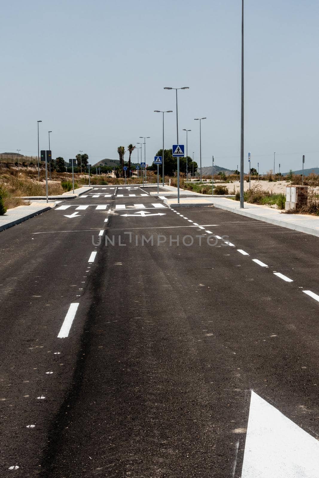 new road markings and road signs on freshly tarmacked roads on spanish urbanisation