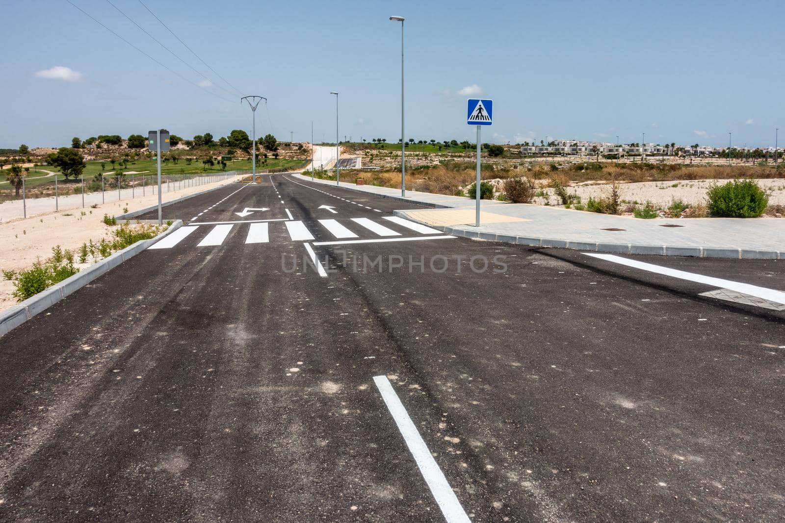 new road markings and road signs on freshly tarmacked roads on spanish urbanisation