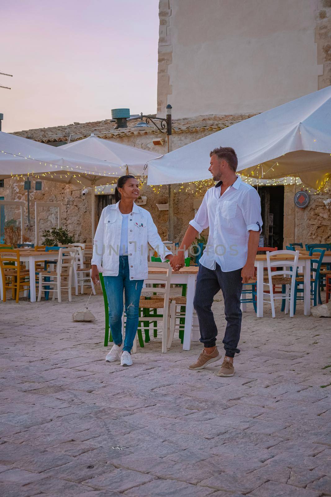 The picturesque village of Marzamemi, in the province of Syracuse, Sicily Italy, a couple on vacation in Sicilia