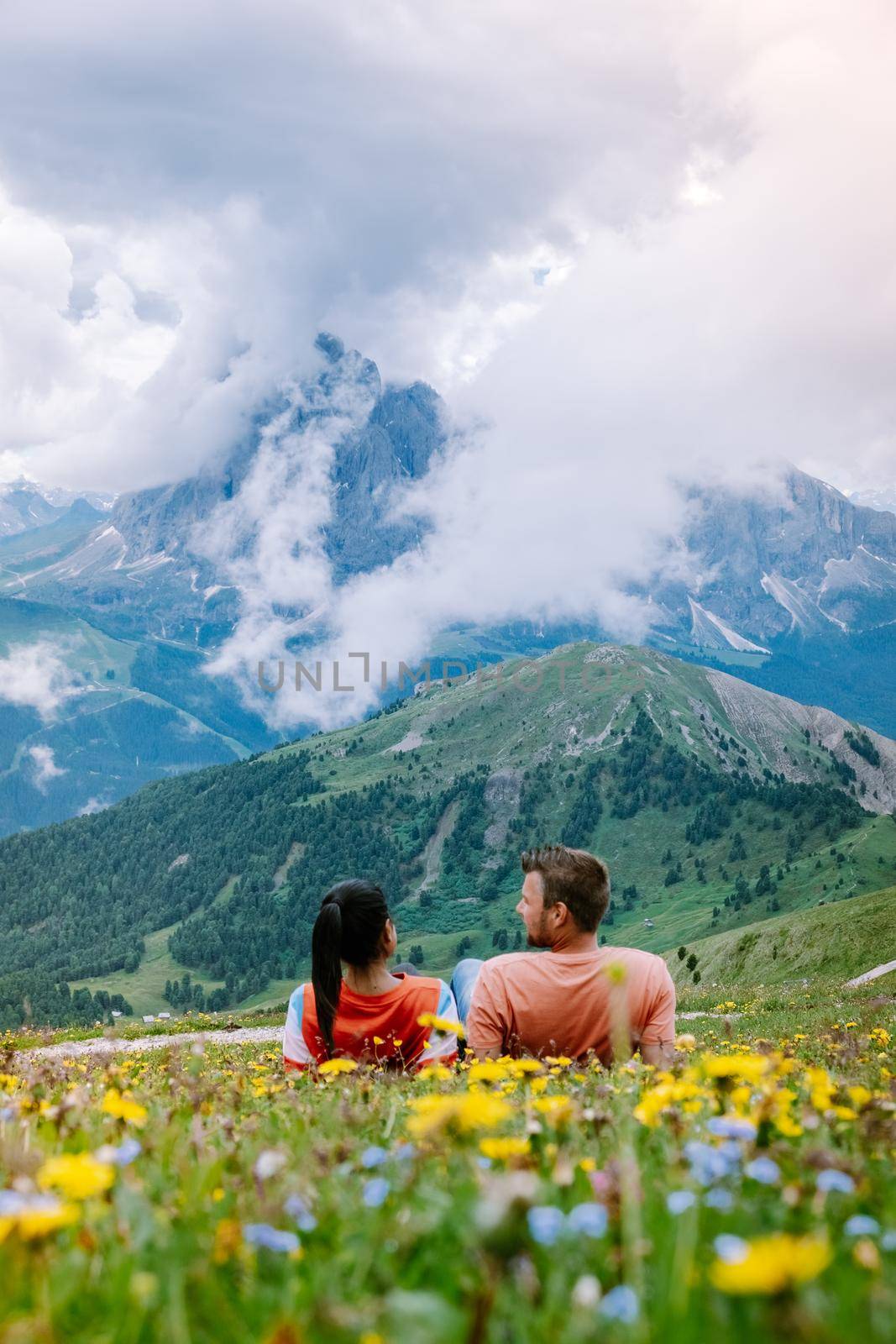 couple on vacation hiking in the Italien Dolomites, Amazing view on Seceda peak. Dolomites Alps, South Tyrol, Italy,  by fokkebok