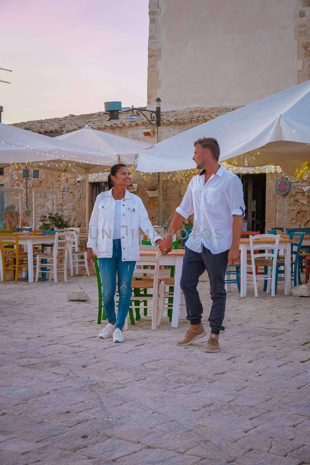 The picturesque village of Marzamemi, in the province of Syracuse, Sicily Italy, a couple on vacation in Sicilia