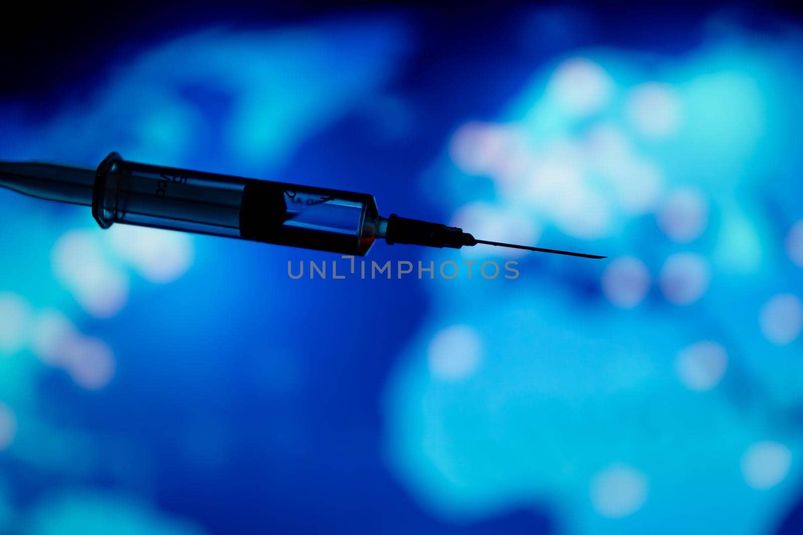 Medical syringe for a vaccine. Blue background