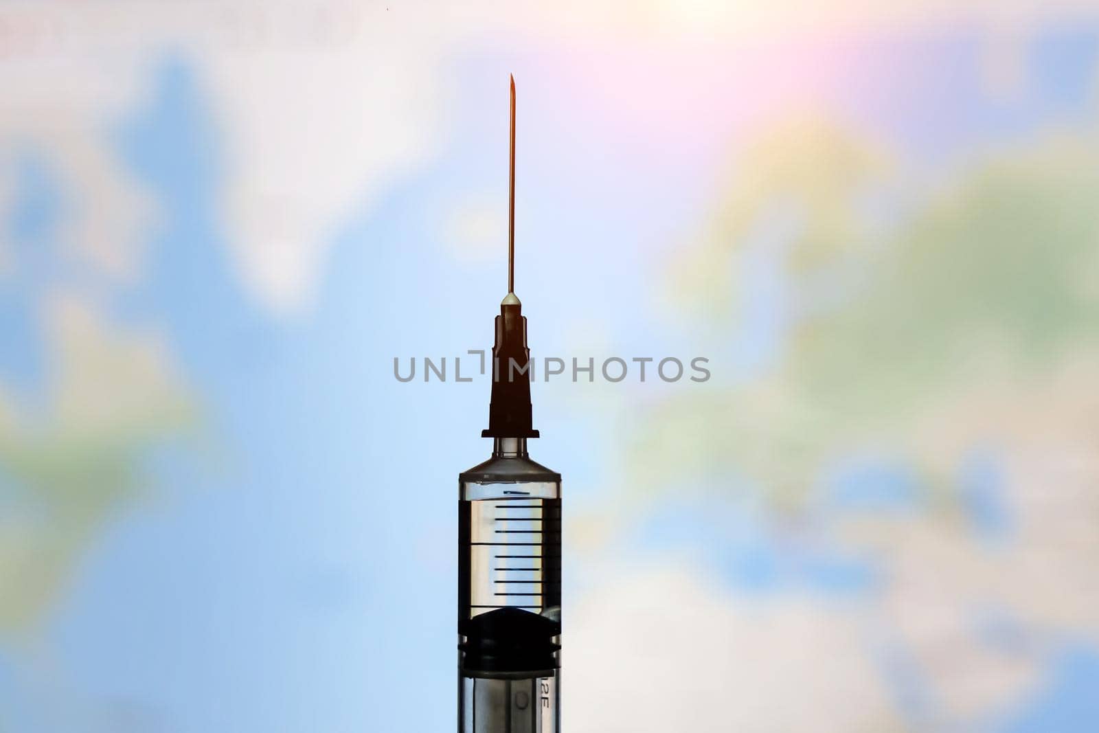 Syringe with vaccine on world map background