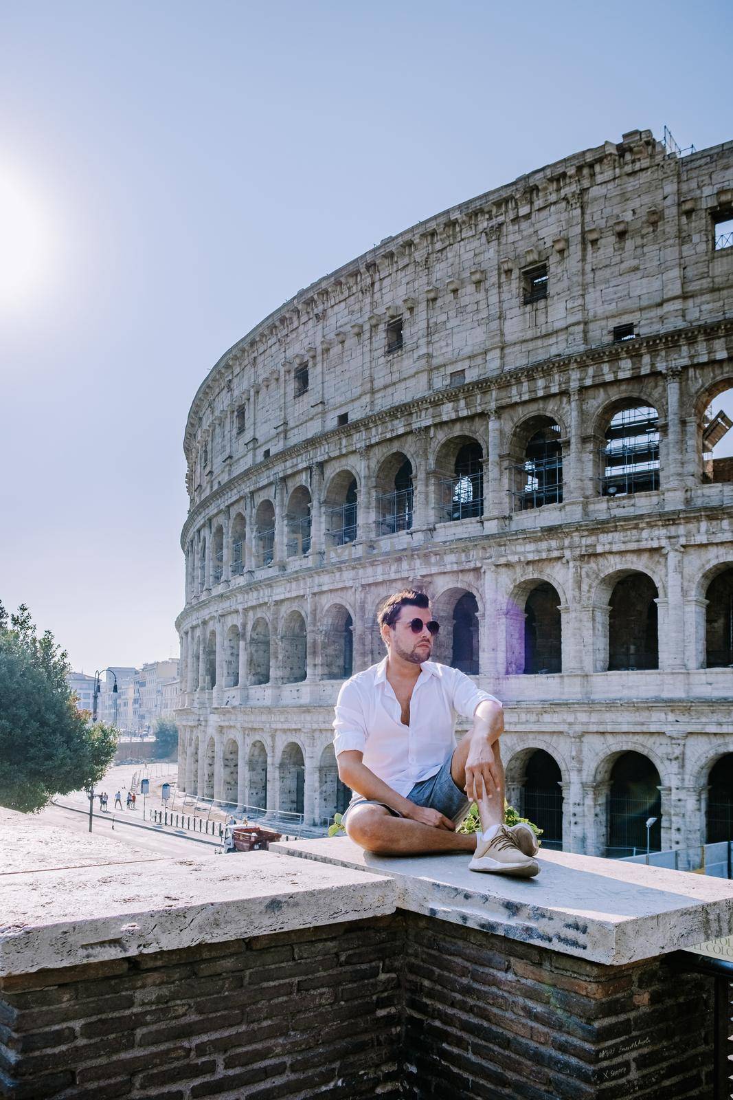 View of Colosseum in Rome and morning sun, Italy, Europe. young guy on city trip Rome
