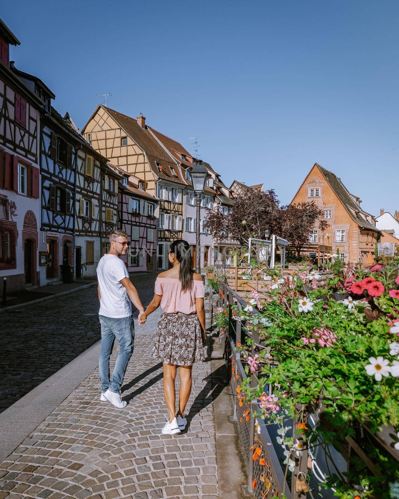 couple on city trip Colmar, Alsace, France. Petite Venice, water canal and traditional half timbered houses. Colmar is a charming town in Alsace, France. Beautiful view of colorful romantic city Colmar