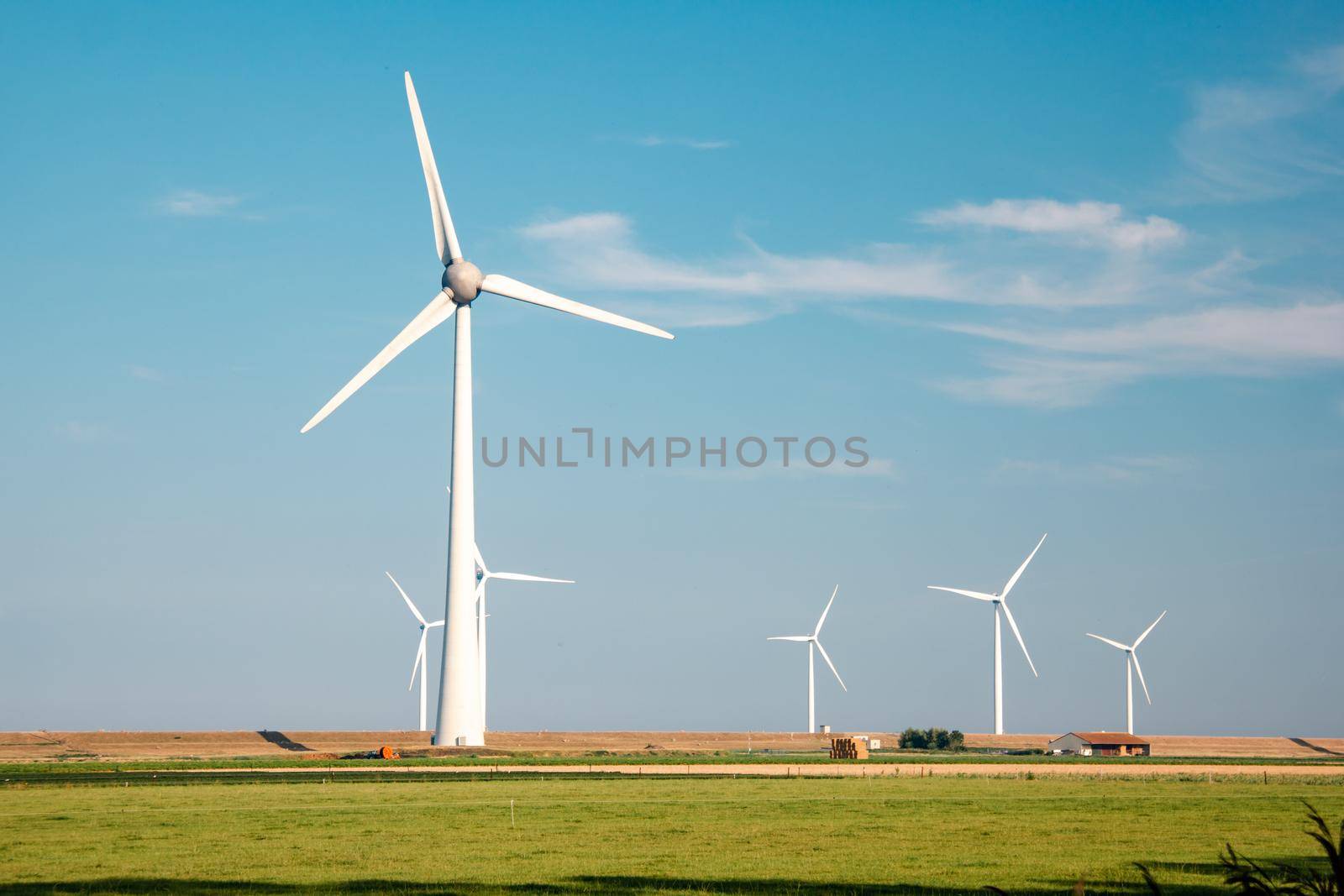 offshore windmill park with stormy clouds and a blue sky, windmill park in the ocean. Netherlands Europe