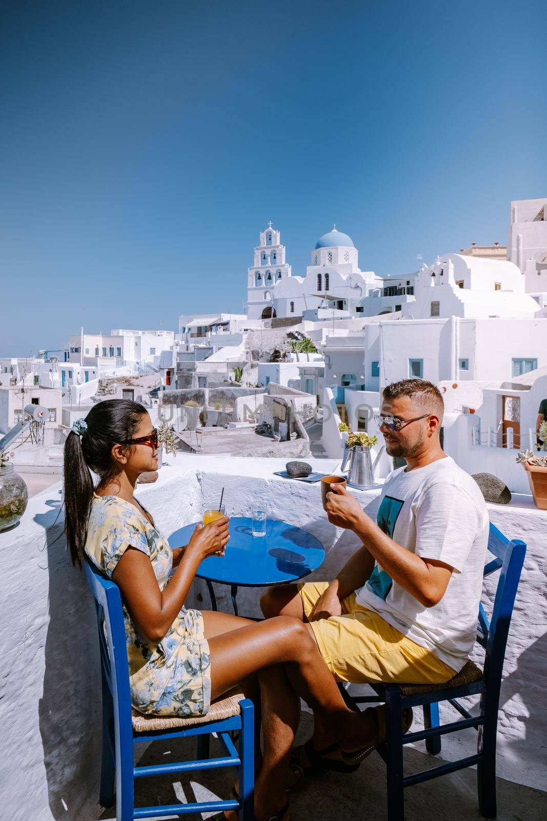 Pyrgos, Santorini, Greece. Famous attraction of white village with cobbled streets, Greek Cyclades Islands, Aegean Sea couple on vacation Santorini Greece Europe