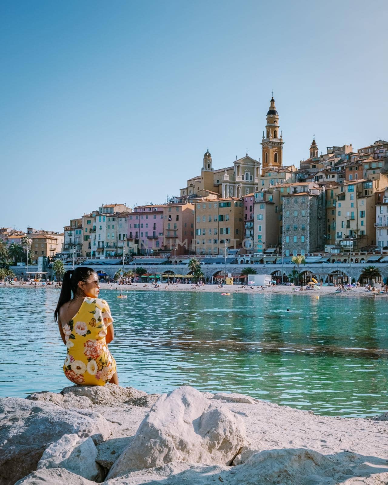 Menton France, woman on vacation at the Cote d Azur France, View on old part of Menton, Provence-Alpes-Cote d'Azur, France by fokkebok