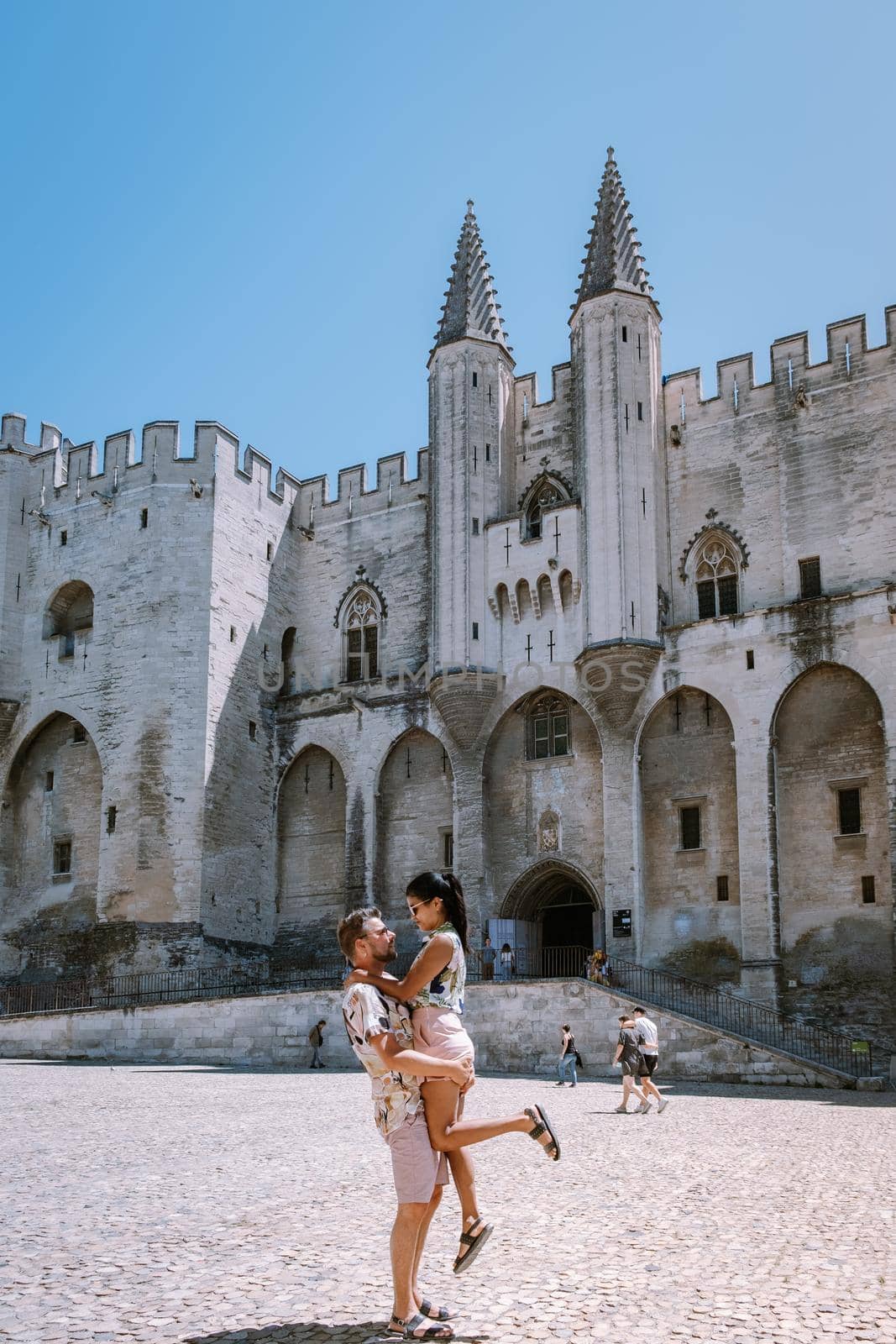 couple city trip Avignon Southern France, Ancient Popes Palace, Saint-Benezet, Avignon, Provence, France by fokkebok