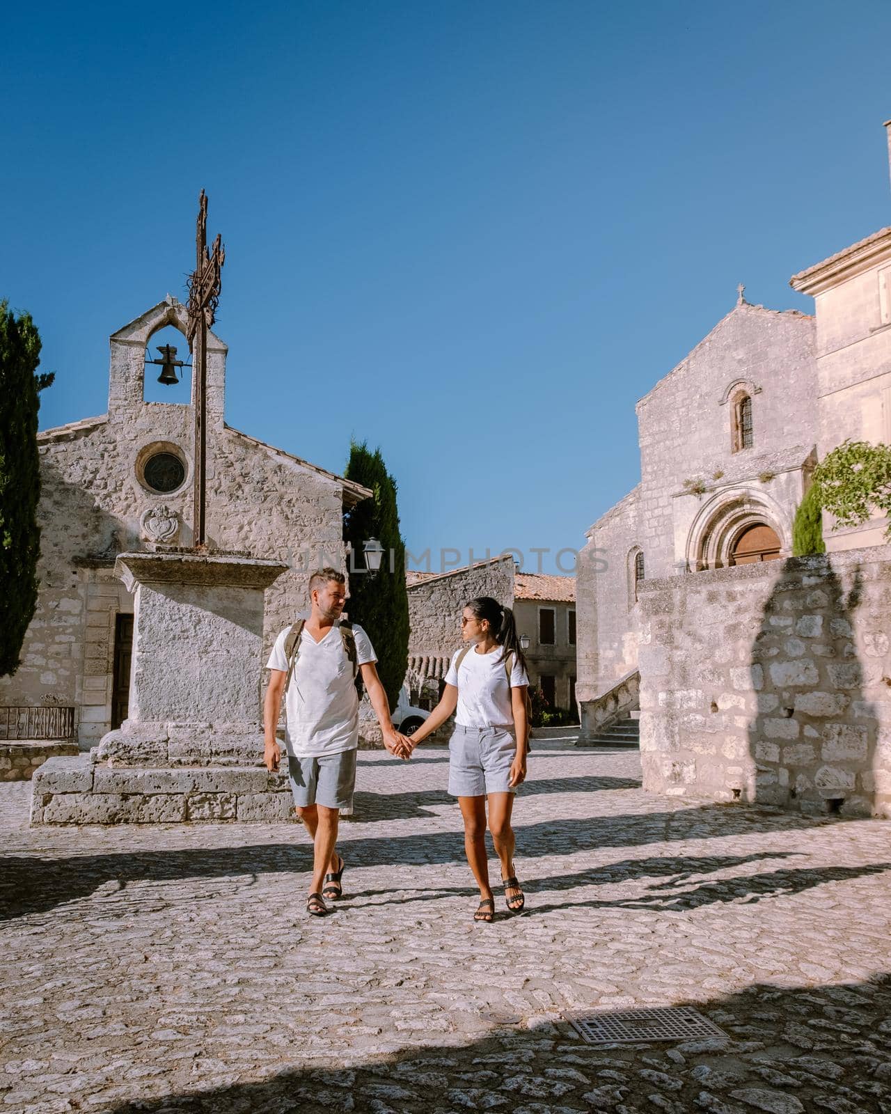 couple visit the town of Les Baux de Provence France, old historical village build on a hill in the Provence, Les Baux de Provence village on the rock formation and its castle. France, Europe by fokkebok