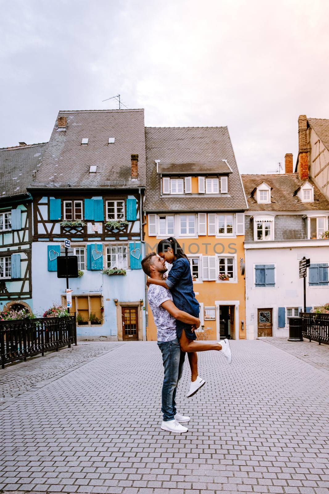 couple on city trip Colmar, Alsace, France. Petite Venice, water canal and traditional half timbered houses. Colmar is a charming town in Alsace, France. Beautiful view of colorful romantic city Colmar, France, Alsace by fokkebok