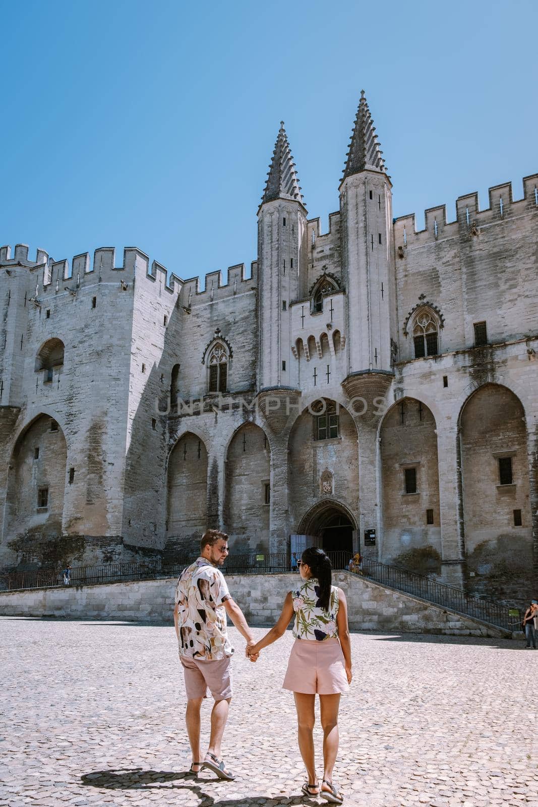 couple city trip Avignon Southern France, Ancient Popes Palace, Saint-Benezet, Avignon, Provence, France by fokkebok