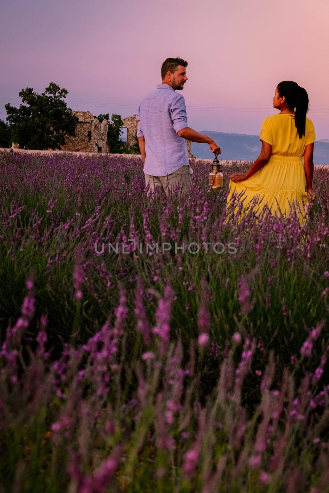 Couple men and woman on vacation at the provence lavender fields, Provence, Lavender field France, Valensole Plateau, colorful field of Lavender Valensole Plateau, Provence, Southern France. Lavender field by fokkebok