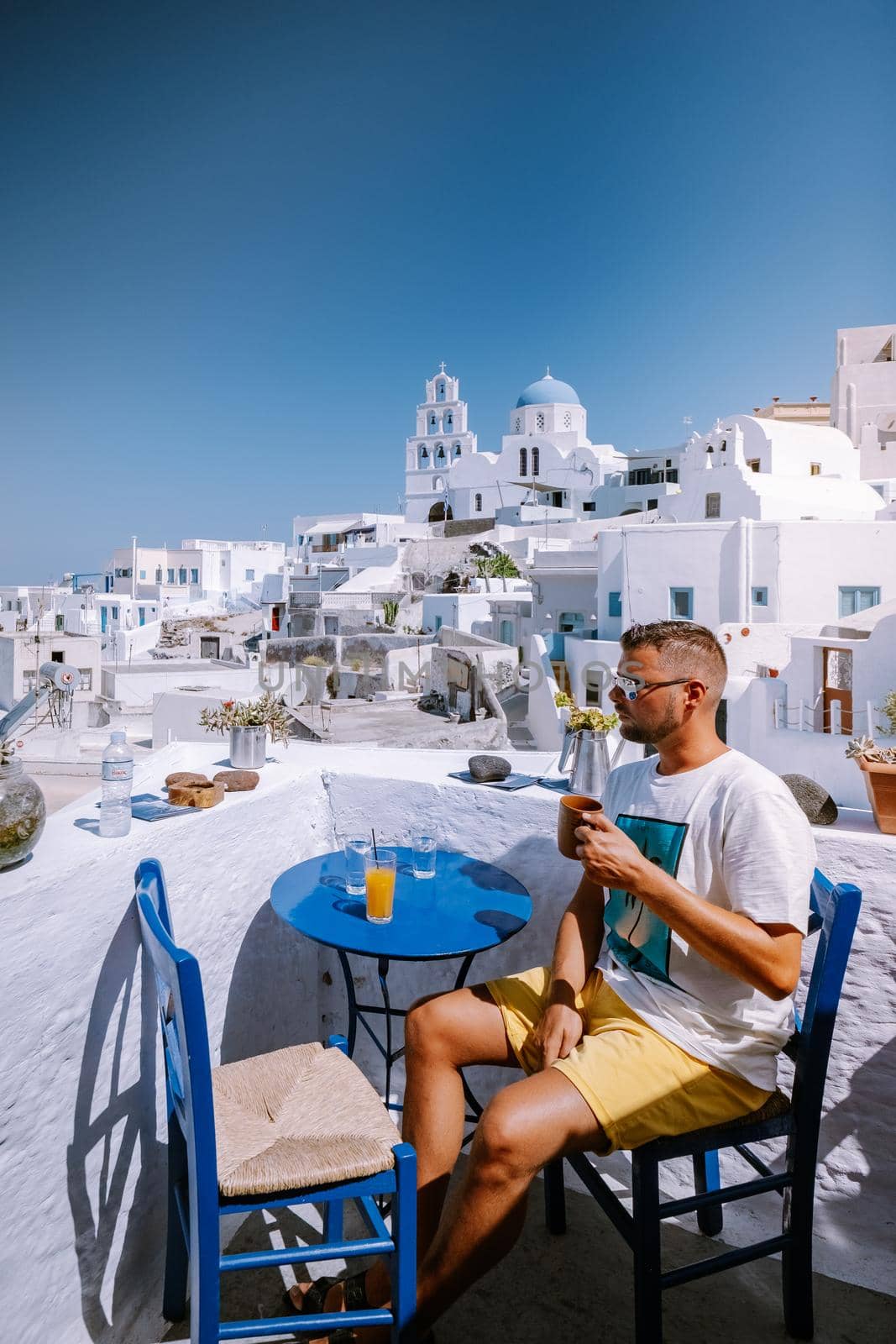Santorini Greece, guy on vacation in Greece, young men on a luxury holiday at the island of Oia Greece by fokkebok