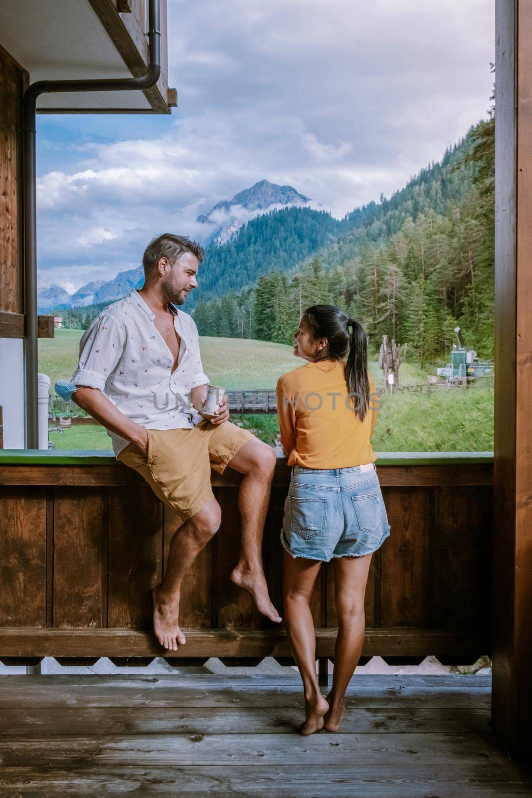 couple on vacation in the Dolomites Italy, small church during cloudy foggy weather, San Vigilio di Marebbe,South Tirol,Italy San Vigilio di Marebbe small town in Dolomites mountain by fokkebok