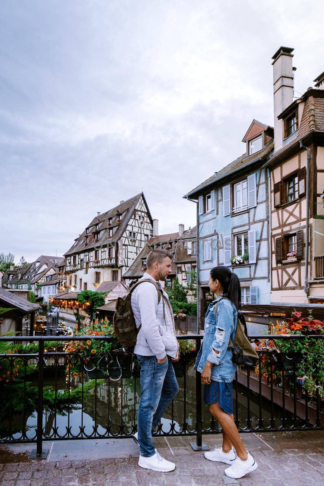 couple on city trip Colmar, Alsace, France. Petite Venice, water canal and traditional half timbered houses. Colmar is a charming town in Alsace, France. Beautiful view of colorful romantic city Colmar, France, Alsace by fokkebok