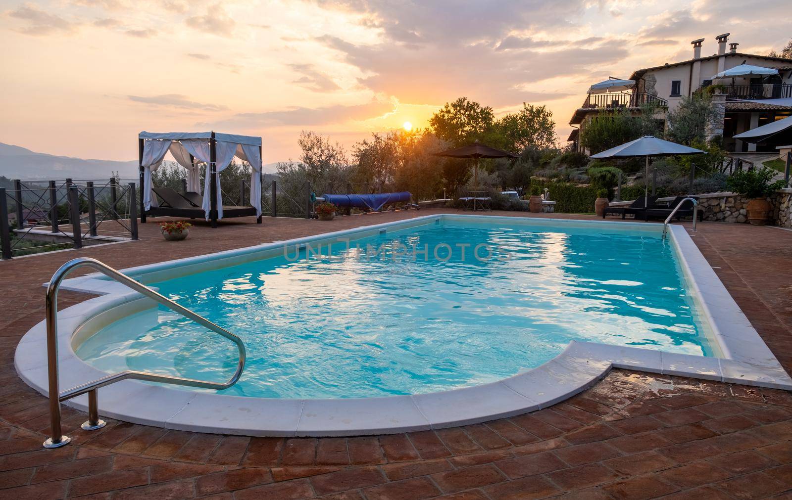 Luxury country house with swimming pool in Italy. Pool and old farm house during sunset central Italy. 