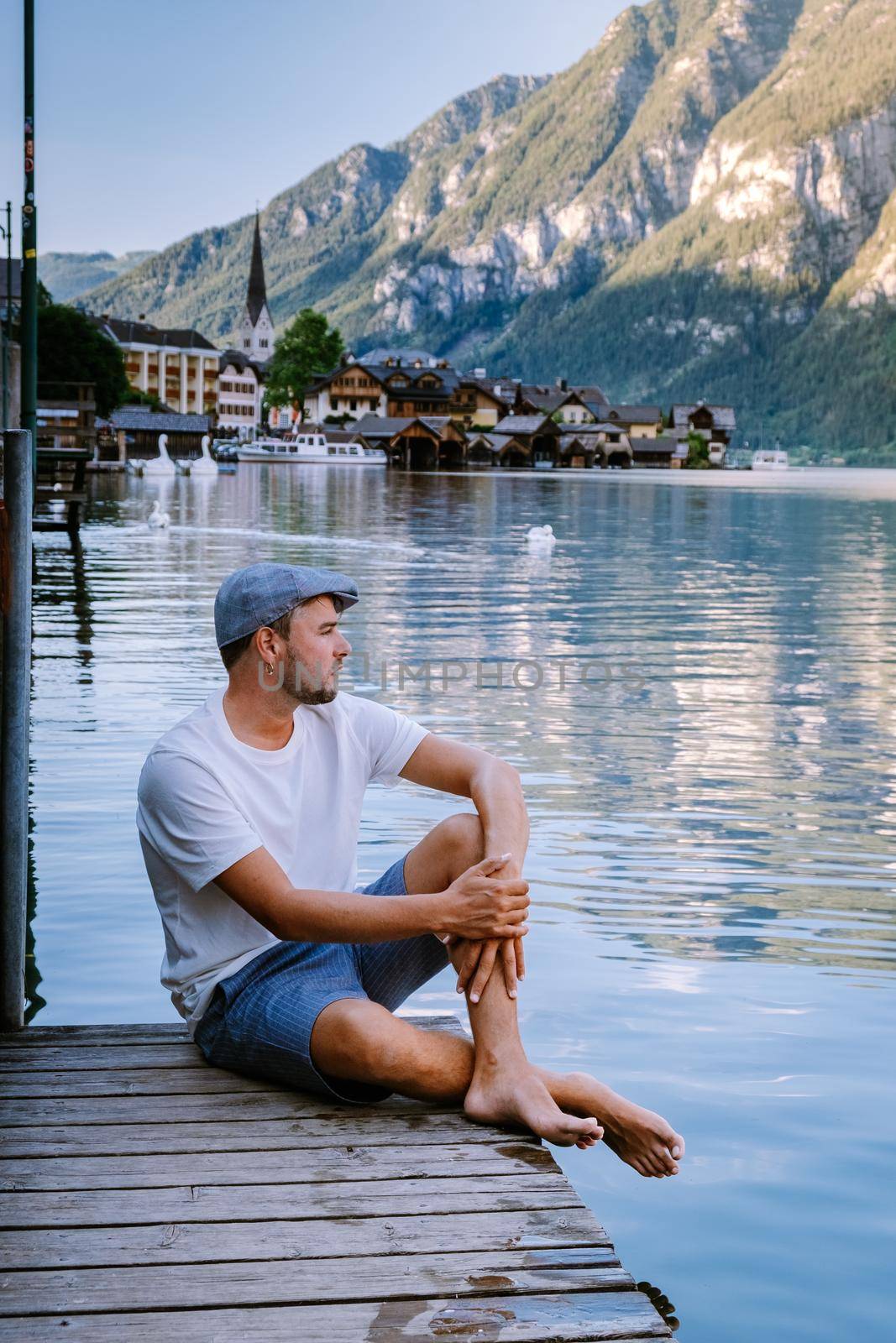 men visit during summer vacation Hallstatt village on Hallstatter lake in Austrian Alps Austria Europe
