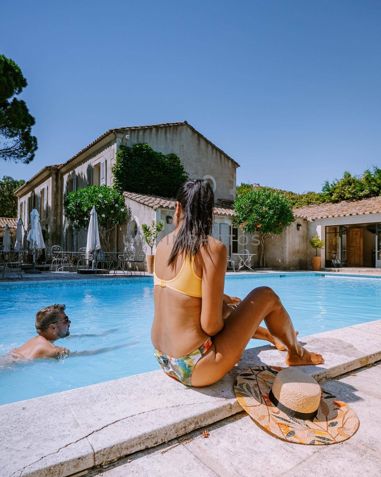 couple relaxing by the pool in the Provence France, men and woman relaxing by pool at luxury resort France