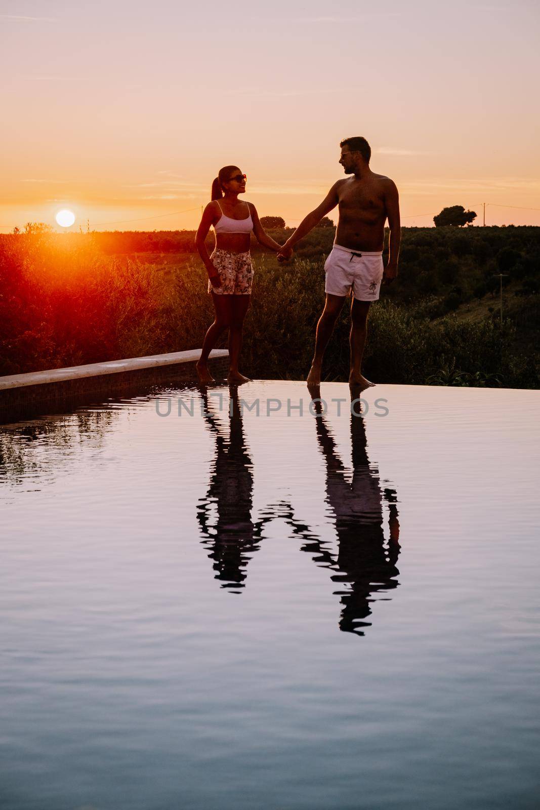 Luxury resort with a view over the wine field in Selinunte Sicily Italy. infinity pool with a view over wine fields in Sicilia, a couple on luxury vacation at the Island of Sicily Italy