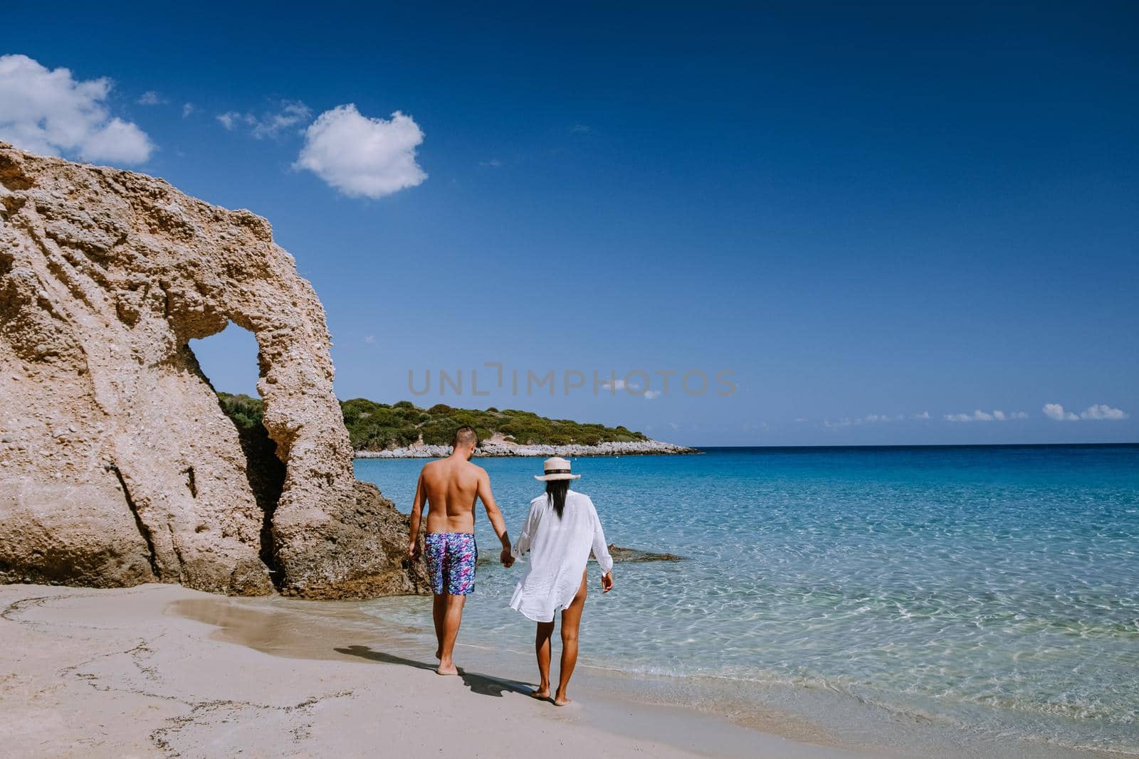 Tropical beach of Voulisma beach, Istron, Crete, Greece, couple on vacation in Greece by fokkebok