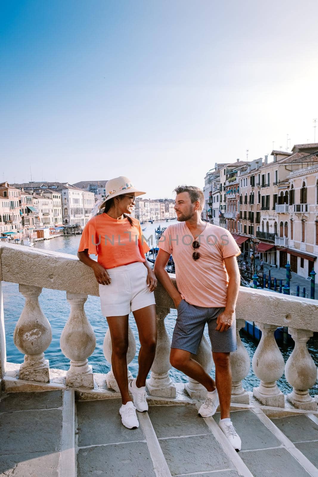 couple men and woman on a city trip to Venice Italy, colorful streets with canals Venice by fokkebok