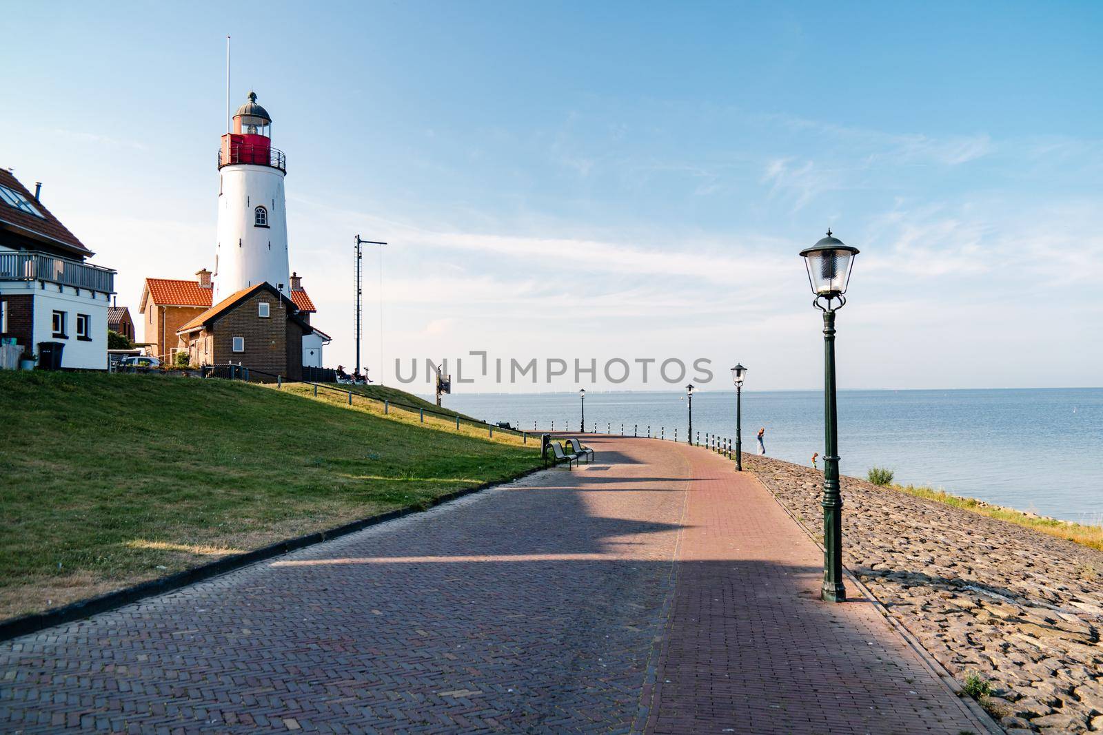 Urk Netherlands harbor and lighthouse near the beach on a bright summer day Flevoland Urk Netherlands by fokkebok