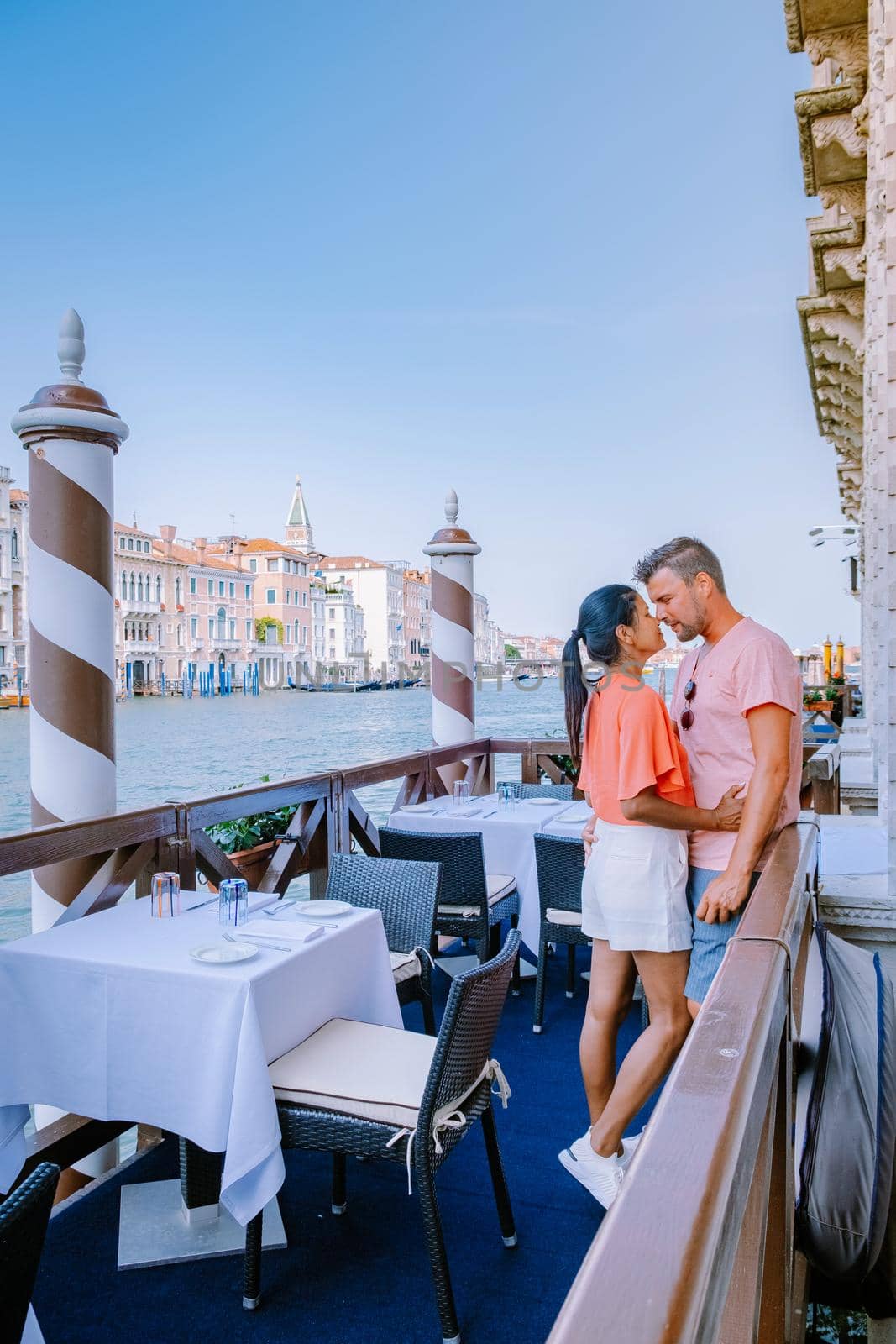 couple men and woman on a city trip to Venice Italy, colorful streets with canals Venice by fokkebok